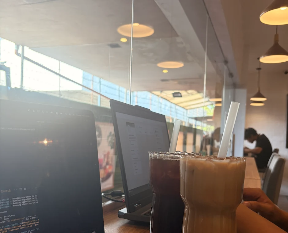 Laptop and drinks at a cafe while working.